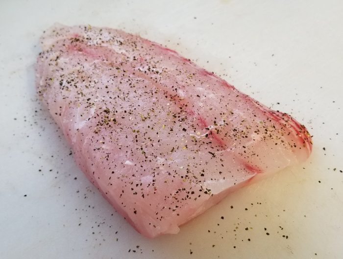 add salt, pepper and spices to fish fillet
