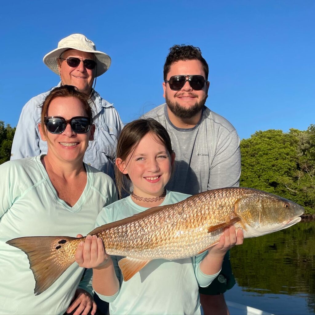 family fishing for redfish on tampa bay